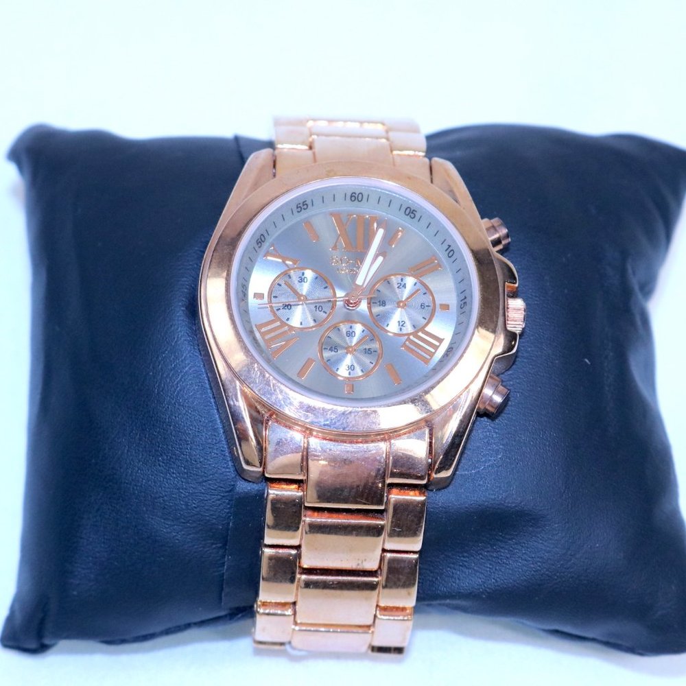 This is a new gold-toned stainless steel watch.